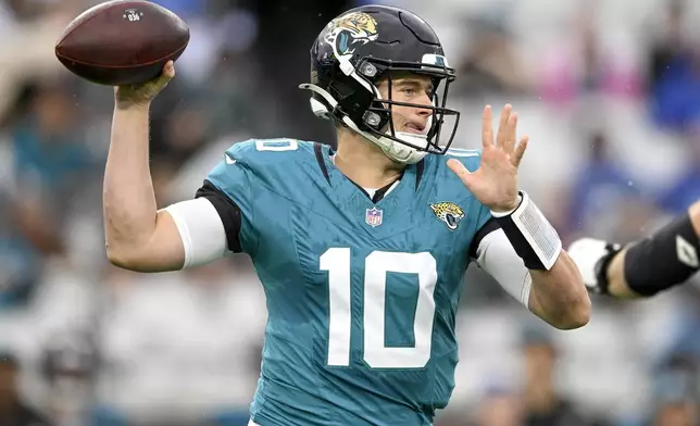 Jacksonville Jaguars quarterback Mac Jones (10) looks to throw a pass during the first half of an NFL football game against the Tennessee Titans, Sunday, Dec. 29, 2024, in Jacksonville, Fla. (AP Photo/Phelan M. Ebenhack)