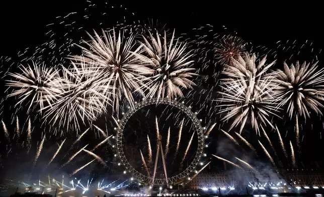 FILE - Fireworks light-up the sky over the London Eye in central London to celebrate the New Year on Monday, Jan. 1, 2024. (AP Photo/Alberto Pezzali, File)