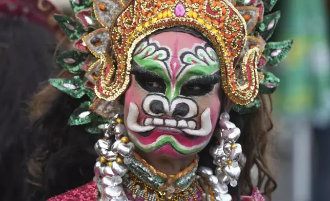 A Cambodian dancer with painted face waits before performing during the "Celebrating Cambodia" event as part of the New Year's Eve in front of Royal Palace in Phnom Penh, Cambodia, Tuesday Dec. 31, 2024. (AP Photo/Heng Sinith)