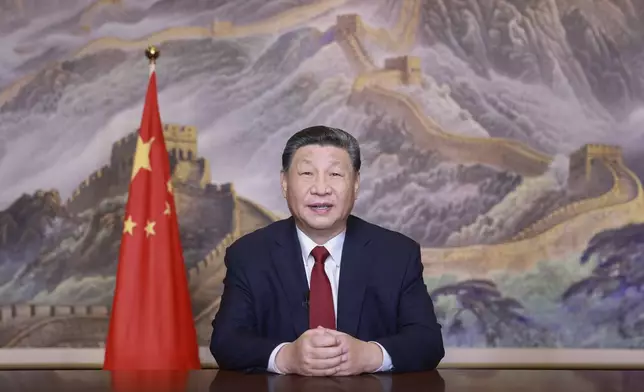 In this photo released by Xinhua News Agency, Chinese President Xi Jinping delivers a New Year message on Tuesday, Dec. 31, 2024 in Beijing to ring in 2025. (Ju Peng/Xinhua via AP)