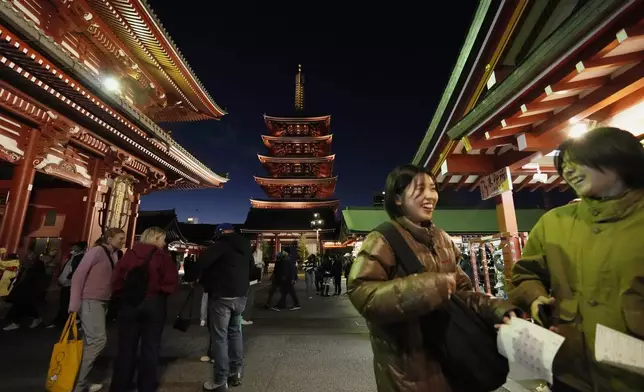 People visit Sensoji Buddhist temple on New Year's Eve in Tokyo, Tuesday, Dec. 31, 2024. (AP Photo/Hiro Komae)