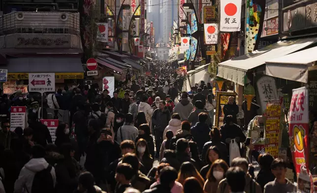 People crowd the famed "Ameyoko" shopping street on New Year's Eve in Tokyo, Tuesday, Dec. 31, 2024. (AP Photo/Hiro Komae)