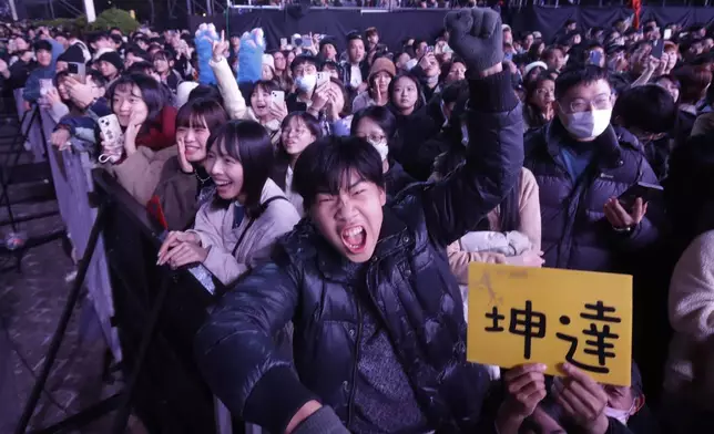 People cheer during the 2025 Taipei New Year's Party celebration in front of the Taipei City Government Building in Taipei, Taiwan, Tuesday, Dec. 31, 2024. (AP Photo/Chiang Ying-ying)