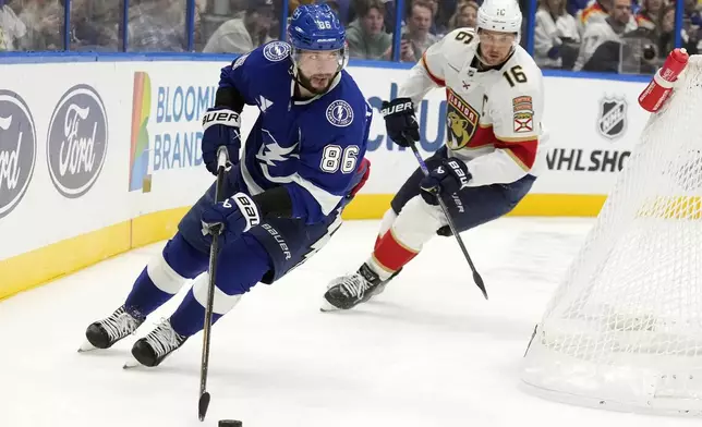 Tampa Bay Lightning right wing Nikita Kucherov (86) skates ahead of Florida Panthers center Aleksander Barkov (16) during the second period of an NHL hockey game Sunday, Dec. 22, 2024, in Tampa, Fla. (AP Photo/Chris O'Meara)