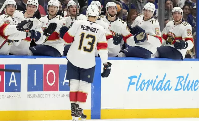 Florida Panthers center Sam Reinhart (13) celebrates with the bench after his goal against the Tampa Bay Lightning during the first period of an NHL hockey game Sunday, Dec. 22, 2024, in Tampa, Fla. (AP Photo/Chris O'Meara)