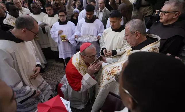 Latin Patriarch Pierbattista Pizzaballa, the top Catholic clergyman in the Holy Land, center, arrives at the Church of the Nativity, traditionally believed to be the birthplace of Jesus, on Christmas Eve in the West Bank city of Bethlehem, Tuesday, Dec. 24, 2024. (AP Photo/Matias Delacroix)