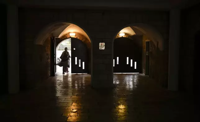 A worshipper leaves the Church of the Nativity where Christians believe Jesus Christ was born, ahead of Christmas in the West Bank city of Bethlehem, Monday, Dec. 23, 2024. (AP Photo/Matias Delacroix)