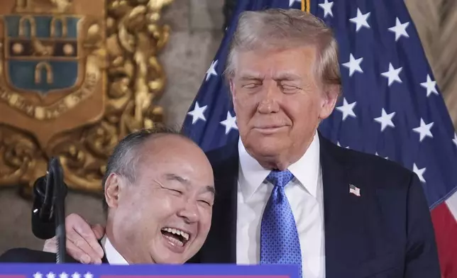 SoftBank Group CEO Masayoshi Son smiles with President-elect Donald Trump during a news conference at Mar-a-Lago, Monday, Dec. 16, 2024, in Palm Beach, Fla. (AP Photo/Evan Vucci)