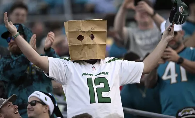 A New York Jets fan reacts to a missed field goal during the second half of an NFL football game against the Jacksonville Jaguars Sunday, Dec. 15, 2024, in Jacksonville, Fla. (AP Photo/Phelan M. Ebenhack)