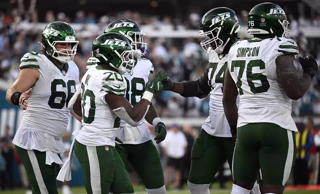 New York Jets running back Breece Hall (20) celebrates his touchdown against the Jacksonville Jaguars during the second half of an NFL football game Sunday, Dec. 15, 2024, in Jacksonville, Fla. (AP Photo/Phelan M. Ebenhack)