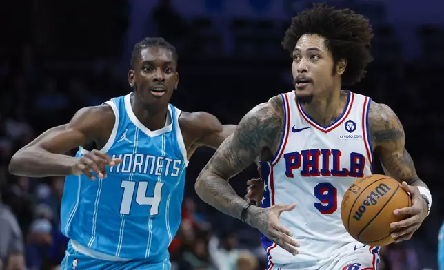 Philadelphia 76ers guard Kelly Oubre Jr. (9) drives to the basket past Charlotte Hornets forward Moussa Diabate (14) during the second half of an NBA basketball game in Charlotte, N.C., Monday, Dec. 16, 2024. (AP Photo/Nell Redmond)