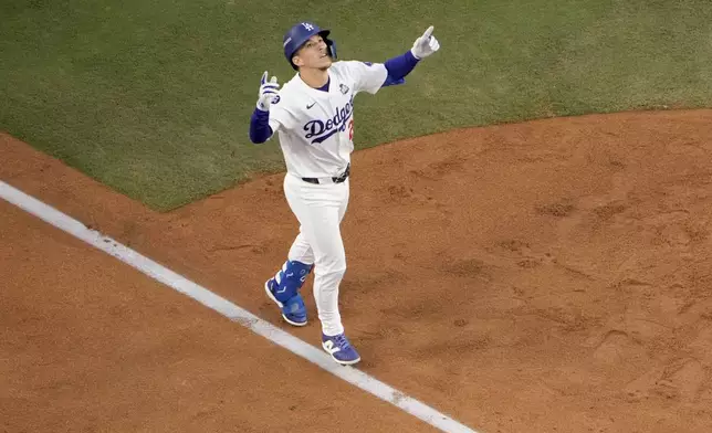 FILE - Los Angeles Dodgers' Tommy Edman celebrates as he reaches home plate after his solo home run during the second inning in Game 2 of the baseball World Series against the New York Yankees, Oct. 26, 2024, in Los Angeles. (AP Photo/Mark J. Terrill, File)