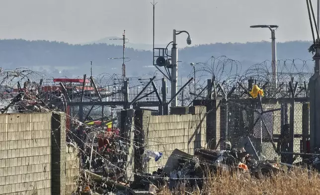 A rescue team works to extinguish a fire at the Muan International Airport in Muan, South Korea, Sunday, Dec. 29, 2024. (Maeng Dae-hwan/Newsis via AP)