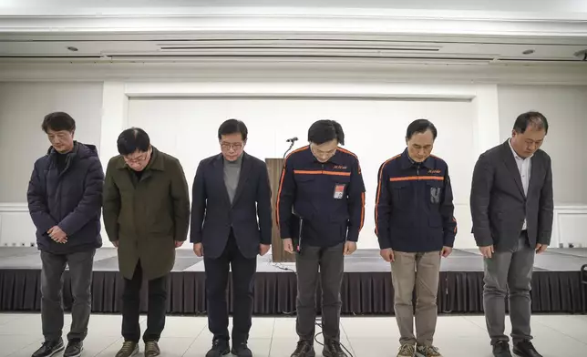 Jeju Air CEO Kim E-bae, fourth from left, and other executive members bow in apology ahead of a briefing in Seoul, South Korea, Sunday, Dec. 29, 2024 after its passenger plane burst into flames at an airport in the town of Muan. (Im Hun-jung/Yonhap via AP)