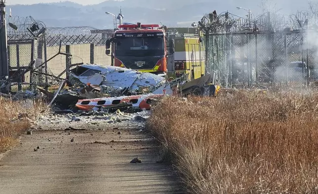 Fire engines work to extinguish a fire at the Muan International Airport in Muan, South Korea, Sunday, Dec. 29, 2024. (Maeng Dae-hwan/Newsis via AP)