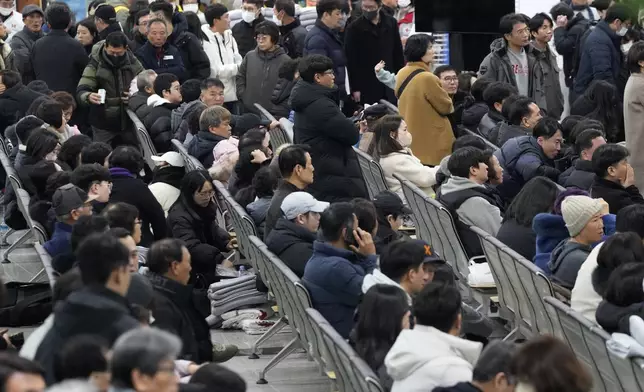 Relatives of passengers gather at Muan International Airport in Muan, South Korea, Sunday, Dec. 29, 2024, after a passenger plane crashed at the airport. (AP Photo/Ahn Young-joon)