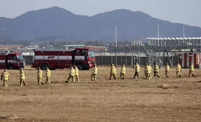 Firefighters and rescue team members work at Muan International Airport in Muan, South Korea, Sunday, Dec. 29, 2024. (Cho Nam-soo/Yonhap via AP)