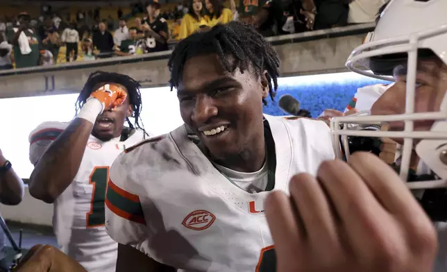 Miami quarterback Cam Ward (1) celebrates after defeating California during an NCAA college football game in Berkeley, Calif., Saturday, Oct. 5, 2024. (AP Photo/Jed Jacobsohn)