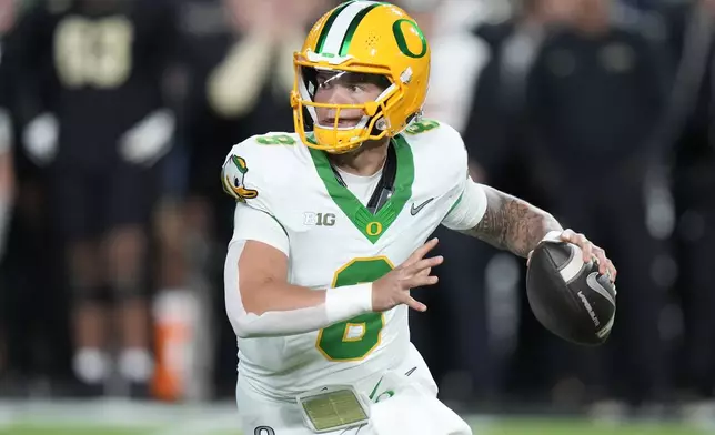 FILE - Oregon quarterback Dillon Gabriel (8) looks to pass while playing Purdue during the first half of an NCAA college football game in West Lafayette, Ind., Friday, Oct. 18, 2024. (AP Photo/AJ Mast, File)