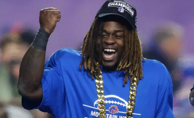 FILE - Boise State running back Ashton Jeanty celebrates after winning the offensive player of the game for the Mountain West Championship NCAA college football game against UNLV, Friday, Dec. 6, 2024, in Boise, Idaho. (AP Photo/Steve Conner, File)