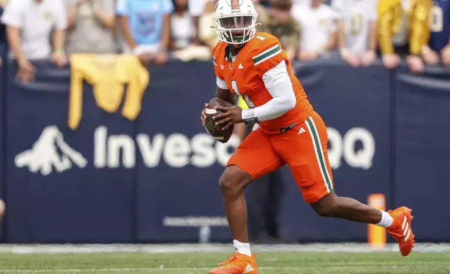 Miami quarterback Cam Ward (1) looks for an open receiver during the first half of an NCAA college football game against the Georgia Tech Yellowjackets, Saturday, Nov. 9, 2024, in Atlanta. (AP Photo/Jason Allen)