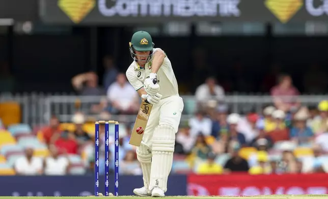 Australia's Nathan McSweeney bats during play on day one of the third cricket test between India and Australia at the Gabba in Brisbane, Australia, Saturday, Dec. 14, 2024. (AP Photo/Pat Hoelscher)