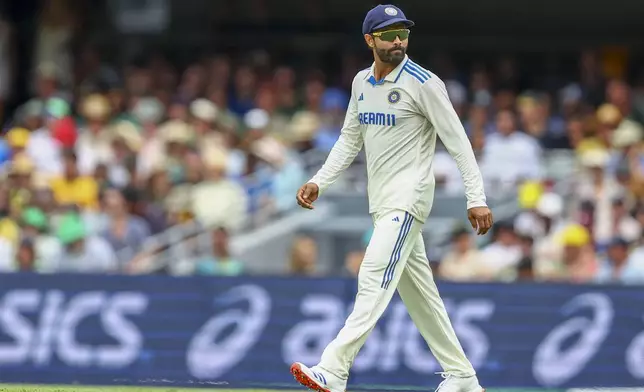 India's Ravindra Jadeja walks back to his fielding position during play on day one of the third cricket test between India and Australia at the Gabba in Brisbane, Australia, Saturday, Dec. 14, 2024. (AP Photo/Pat Hoelscher)