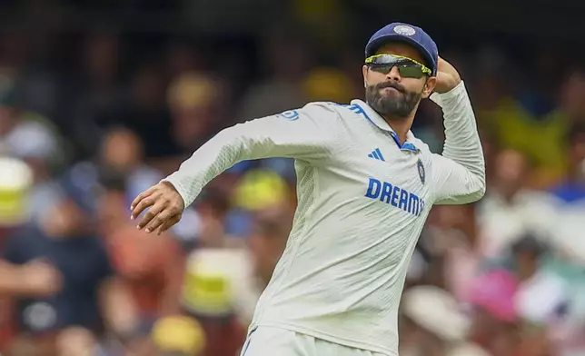India's Ravindra Jadeja prepares to throw a ball after fielding it during play on day one of the third cricket test between India and Australia at the Gabba in Brisbane, Australia, Saturday, Dec. 14, 2024. (AP Photo/Pat Hoelscher)