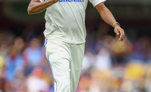 India's Mohammed Siraj tosses the ball as he prepares to bowl on the day one of the third cricket test between India and Australia at the Gabba in Brisbane, Australia, Saturday, Dec. 14, 2024. (AP Photo/Pat Hoelscher)