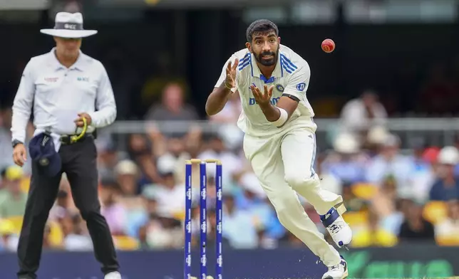 India's Jasprit Bumrah reaches out to field the ball during play on day one of the third cricket test between India and Australia at the Gabba in Brisbane, Australia, Saturday, Dec. 14, 2024. (AP Photo/Pat Hoelscher)