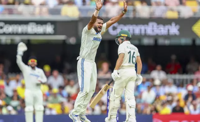 India's Akash Deep, center, appeals unsuccessfully for the wicket of Australia's Nathan McSweeney during play on day one of the third cricket test between India and Australia at the Gabba in Brisbane, Australia, Saturday, Dec. 14, 2024. (AP Photo/Pat Hoelscher)