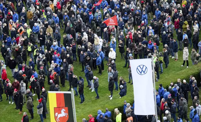 Volkswagen workers attend a rally during at nationwide warning Volkswagen workers' strike, on the grounds of the main Volkswagen plant in Wolfsburg, Germany, Monday, Dec. 2, 2024. (Julian Stratenschulte/Pool Photo via AP)