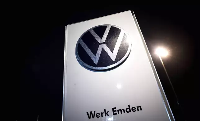 A sign for the Volkswagen plant stands in Emden, Germany, Monday, Dec. 2, 2024. (Sina Schuldt/dpa via AP)