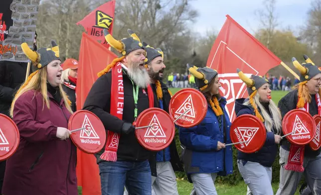 Volkswagen workers demonstrate on the first day of a nationwide warning Volkswagen workers' strike, outside a Volkswagen plant in Wolfsburg, Germany, Monday, Dec. 2, 2024. (Julian Stratenschulte/Pool Photo via AP)