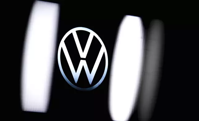 The Volkswagen logo is seen at the company's plant in Emden, Germany, Monday, Dec. 2, 2024. (Sina Schuldt/dpa via AP)