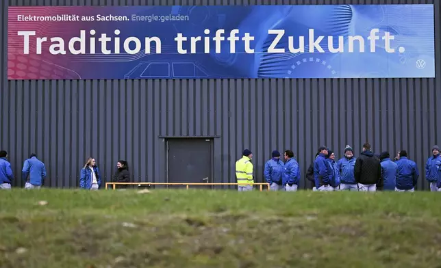 Volkswagen workers gather for a nationwide warning Volkswagen workers' strike, at the Zwickau plant, Germany, Monday, Dec. 2, 2024. Sign at top reads in German ""Tradition meets future". (Hendrik Schmidt/dpa via AP)