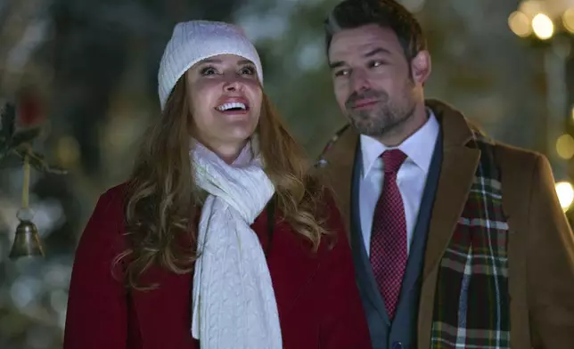 This image released by Great American Family shows Jill Wagner, left, and Jesse Hutch in a scene from "Christmas Under the Northern Lights." (Great American Family via AP)