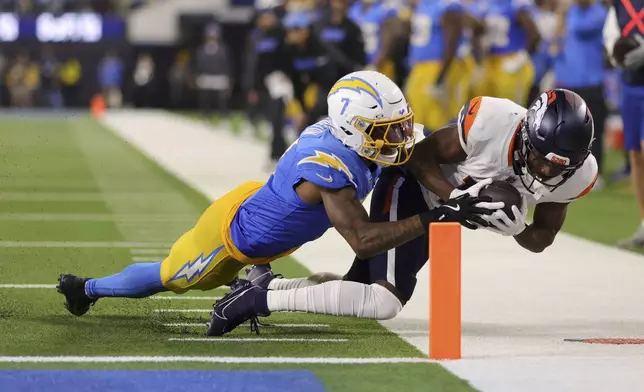 Denver Broncos wide receiver Marvin Mims Jr. (19) is tackled short of the goal line by Los Angeles Chargers cornerback Kristian Fulton (7) during the first half of an NFL football game Thursday, Dec. 19, 2024, in Inglewood, Calif. (AP Photo/Ryan Sun)