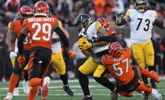 Pittsburgh Steelers tight end MyCole Pruitt is tackled by Cincinnati Bengals linebacker Germaine Pratt (57) during the second half of an NFL football game, Sunday, Dec. 1, 2024, in Cincinnati. (AP Photo/Jeff Dean)