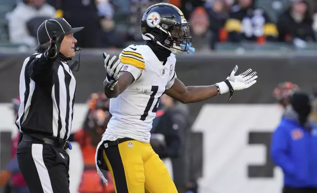 Pittsburgh Steelers wide receiver George Pickens, right, reacts after being flagged with unsportsmanlike conduct during the second half of an NFL football game against the Cincinnati Bengals, Sunday, Dec. 1, 2024, in Cincinnati. (AP Photo/Jeff Dean)