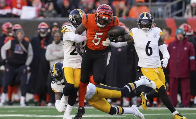 Cincinnati Bengals wide receiver Tee Higgins (5) is tackled by Pittsburgh Steelers safety Damontae Kazee, second from left, during the second half of an NFL football game Sunday, Dec. 1, 2024, in Cincinnati. (AP Photo/Jeff Dean)