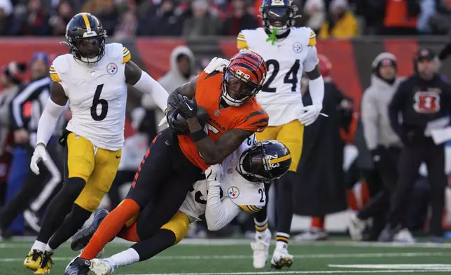 Pittsburgh Steelers safety Damontae Kazee (23) tackles Cincinnati Bengals wide receiver Tee Higgins, center top, during the second half of an NFL football game Sunday, Dec. 1, 2024, in Cincinnati. (AP Photo/Jeff Dean)