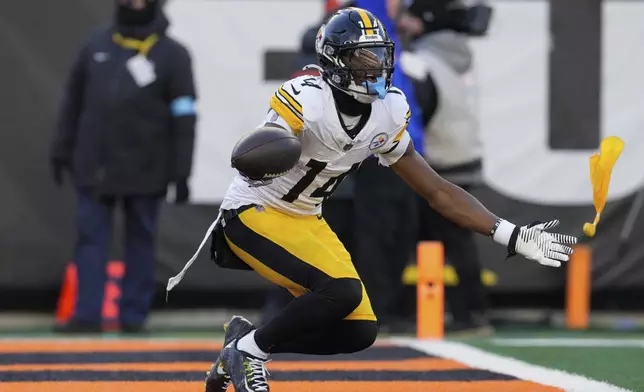 Pittsburgh Steelers wide receiver George Pickens reacts after being flagged with unsportsmanlike conduct during the second half of an NFL football game against the Cincinnati Bengals, Sunday, Dec. 1, 2024, in Cincinnati. (AP Photo/Jeff Dean)