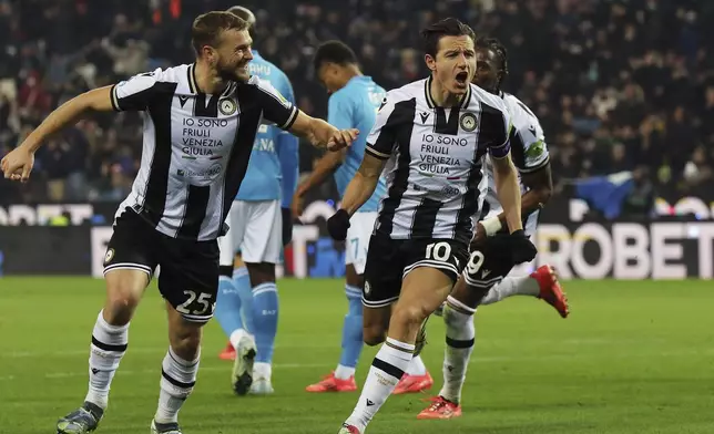 Udinese's Florian Thauvin, right, celebrates after scoring a goal during the Serie A soccer match between Udinese and Napoli at the Bluenergy Stadium in Udine, Italy, Saturday, Dec. 14, 2024. (Andrea Bressanutti/LaPresse via AP)