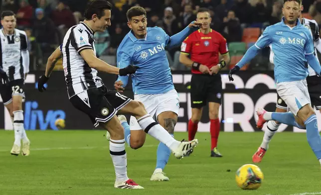 Udinese's Florian Thauvin, left, scores a goal during the Serie A soccer match between Udinese and Napoli at the Bluenergy Stadium in Udine, Italy, Saturday, Dec. 14, 2024. (Andrea Bressanutti/LaPresse via AP)