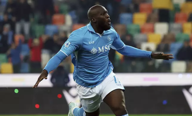 Napoli's Romelu Lukaku celebrates after scoring the 1-1 goal for his team during the Serie A soccer match between Udinese and Napoli at the Bluenergy Stadium in Udine, Italy, Saturday, Dec. 14, 2024. (Andrea Bressanutti/LaPresse via AP)