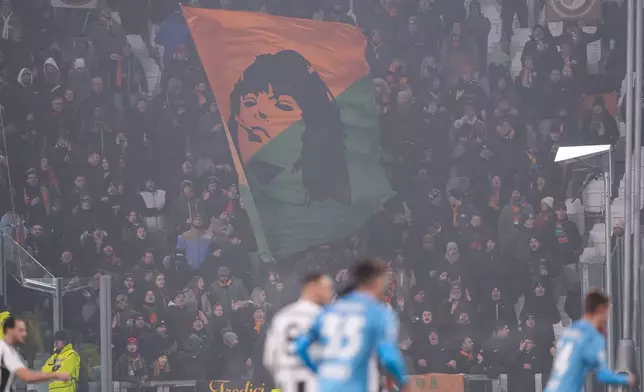 Venezia's fans cheer during the Serie A soccer match between Juventus and Venezia at the Juventus Stadium in Turin, Italy on Saturday, Dec. 14, 2024. (Fabio Ferrari/LaPresse via AP)
