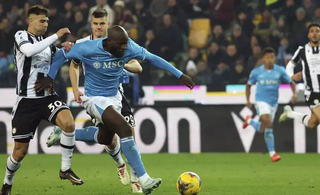 Napoli's Romelu Lukaku celebrates after scoring the 1-1 goal for his team during the Serie A soccer match between Udinese and Napoli at the Bluenergy Stadium in Udine, Italy, Saturday, Dec. 14, 2024. (Andrea Bressanutti/LaPresse via AP)