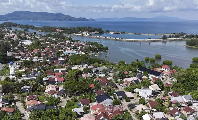 This aerial shot taken using a drone shows the now densely-populated Ulee Lheue village, one of the areas hardest hit by the Indian Ocean tsunami in 20024, in Banda Aceh, Aceh Province, Indonesia, Friday, Dec. 13, 2024. (AP Photo/Achmad Ibrahim)