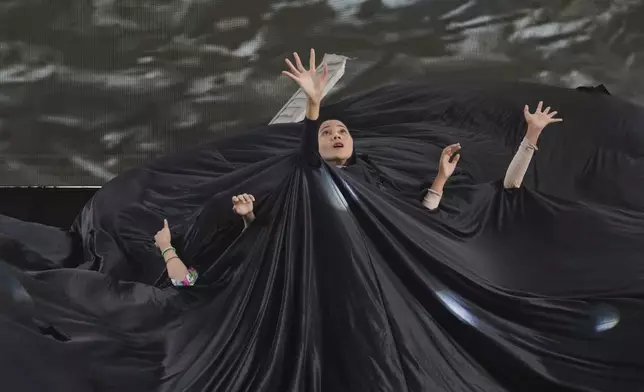 Artists perform during a stage performance depicting the Indian Ocean tsunami during a commemoration of the 20th year since the killer wave ravaged Aceh's coastal areas, in Banda Aceh, Indonesia, Saturday, Dec 14, 2024. (AP Photo/Achmad Ibrahim)